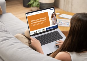woman viewing new LFCU website sitting on couch