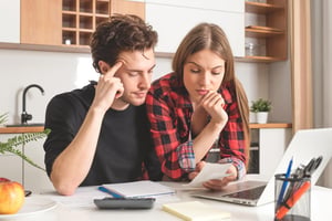 Couple at kitchen counter discussing budget