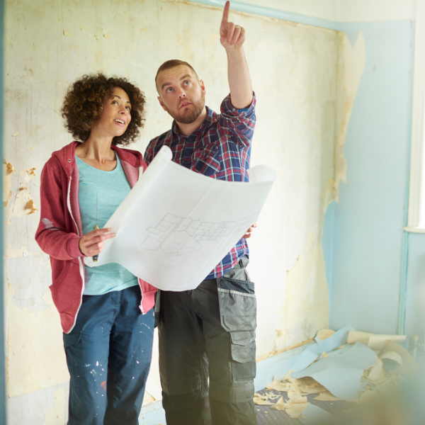 Couple looking at blueprints